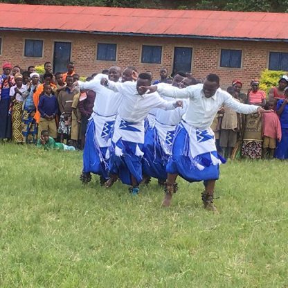 Rwanda dancers in traditional clothing of white and blue