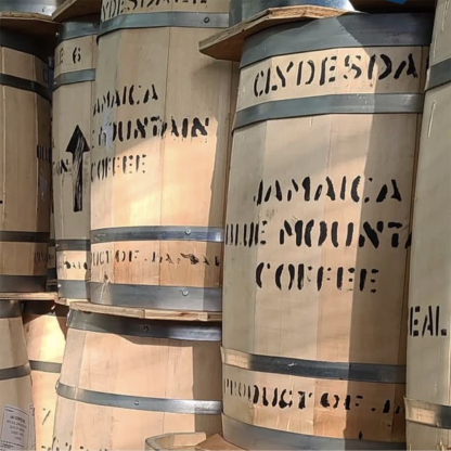 Wood barrels filled with Jamaican Blue Mountain green coffee from the Clydesdale Estate, labelled with the Protected Origin of Designation.