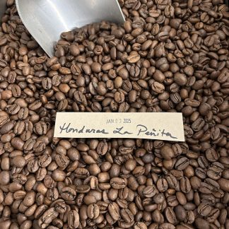 A close-up view of the Honduras, La Peñita roasted coffee beans showing their shape, size, and uniformity of medium roast degree.